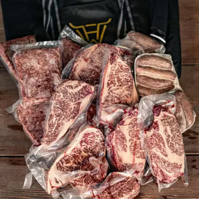 A whole cow share of Holy Wagyu kosher Wagyu cuts, vacuum packed, in a Holy Wagyu delivery bag