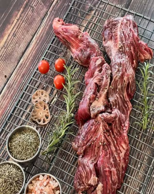 Smoked Wagyu brisket being sliced on a cutting board